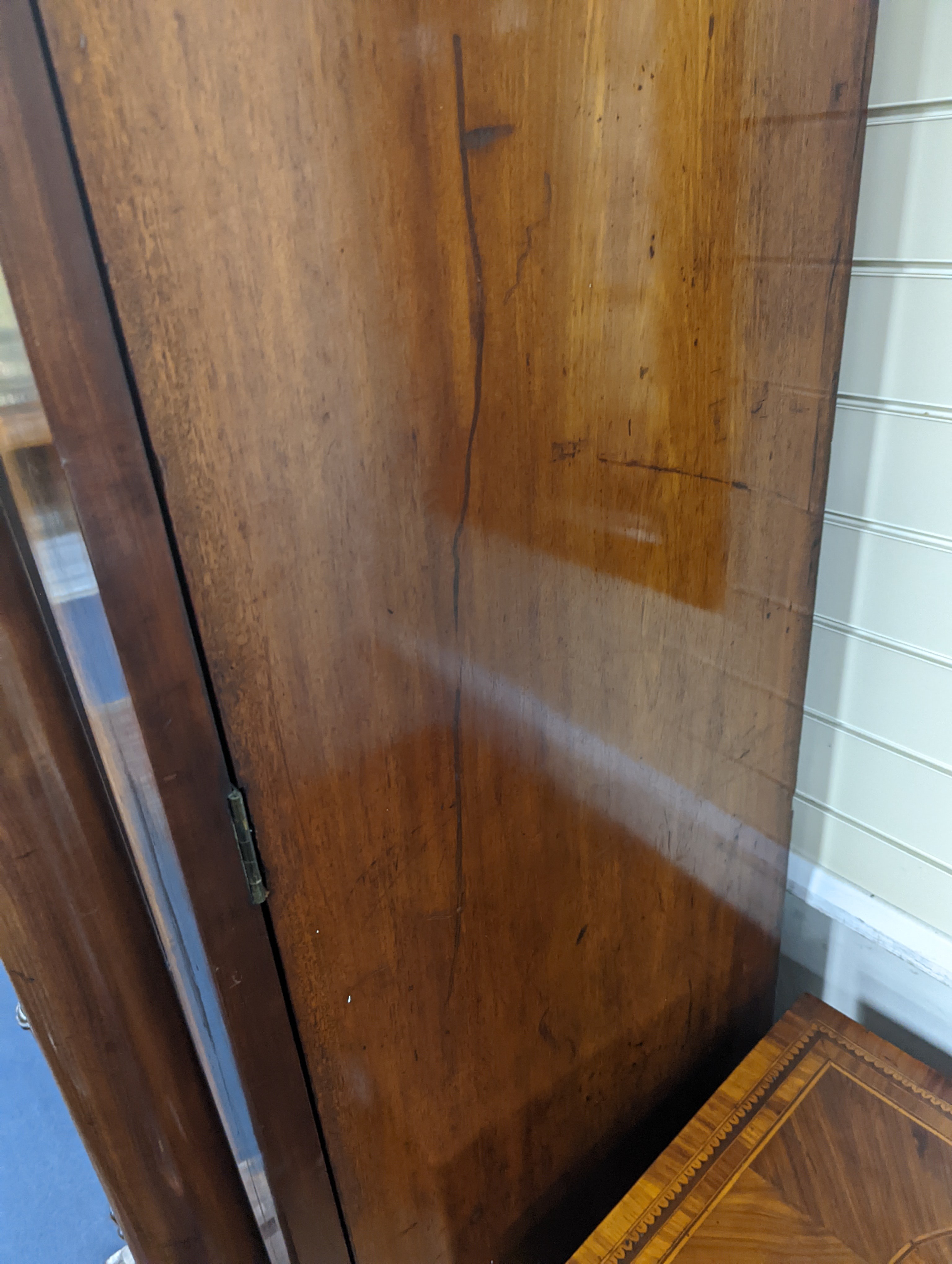 A William IV figured mahogany inverse breakfront compactum wardrobe, length 263cm, depth 70cm, height 197cm